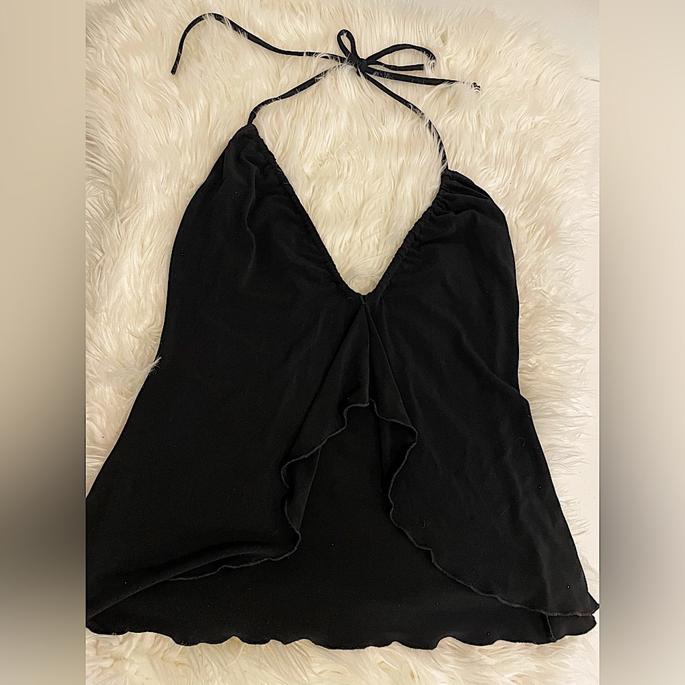 Flirty open flutter front top. Tie and adjusts at neck.